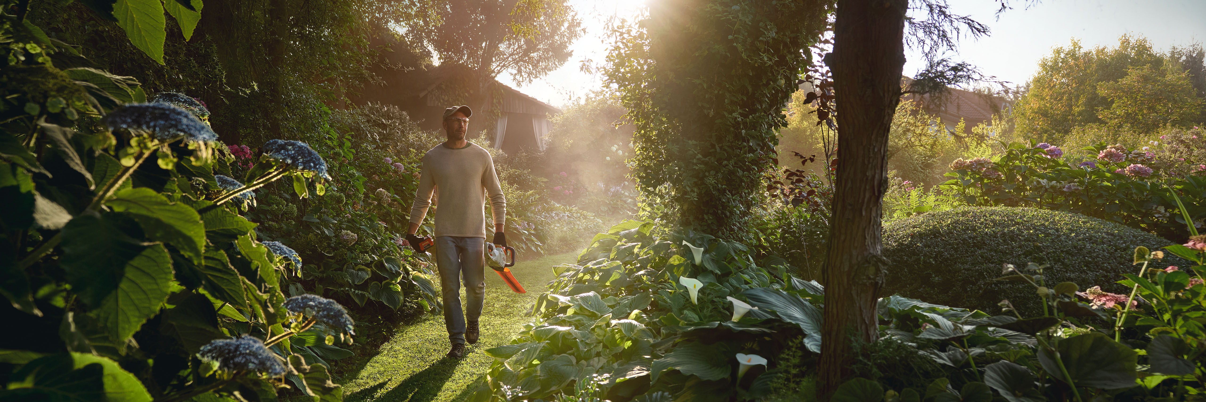 Muž v zahradě s nůžkami STIHL