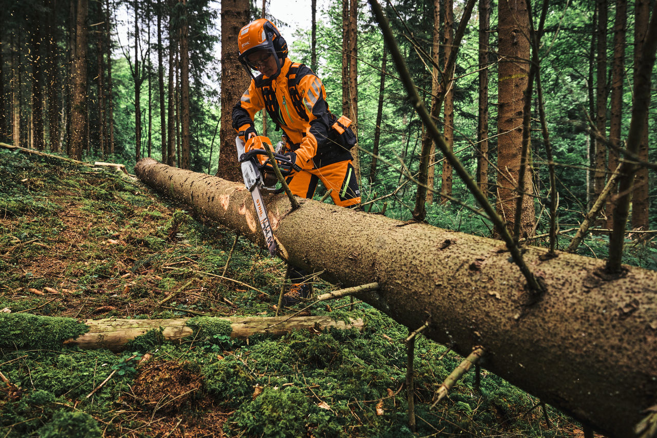 Woodworker wearing STIHL ADVANCE-FlexTEC-ShellTEC while working in the forest
