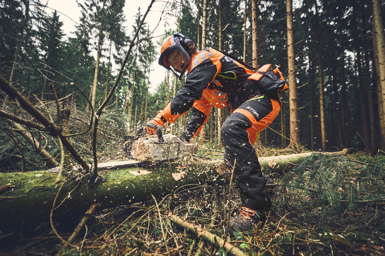 Lesní dělník při práci s motorovou pilou STIHL v ochranném pracovním oděvu ADVANCE FlexTEC ShellTEC. 